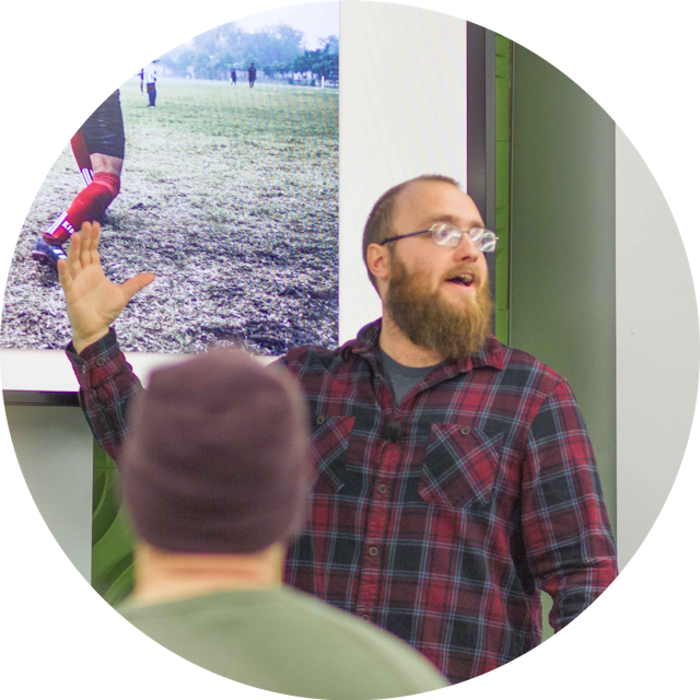 Portrait of me in a flannel delivering a presentation