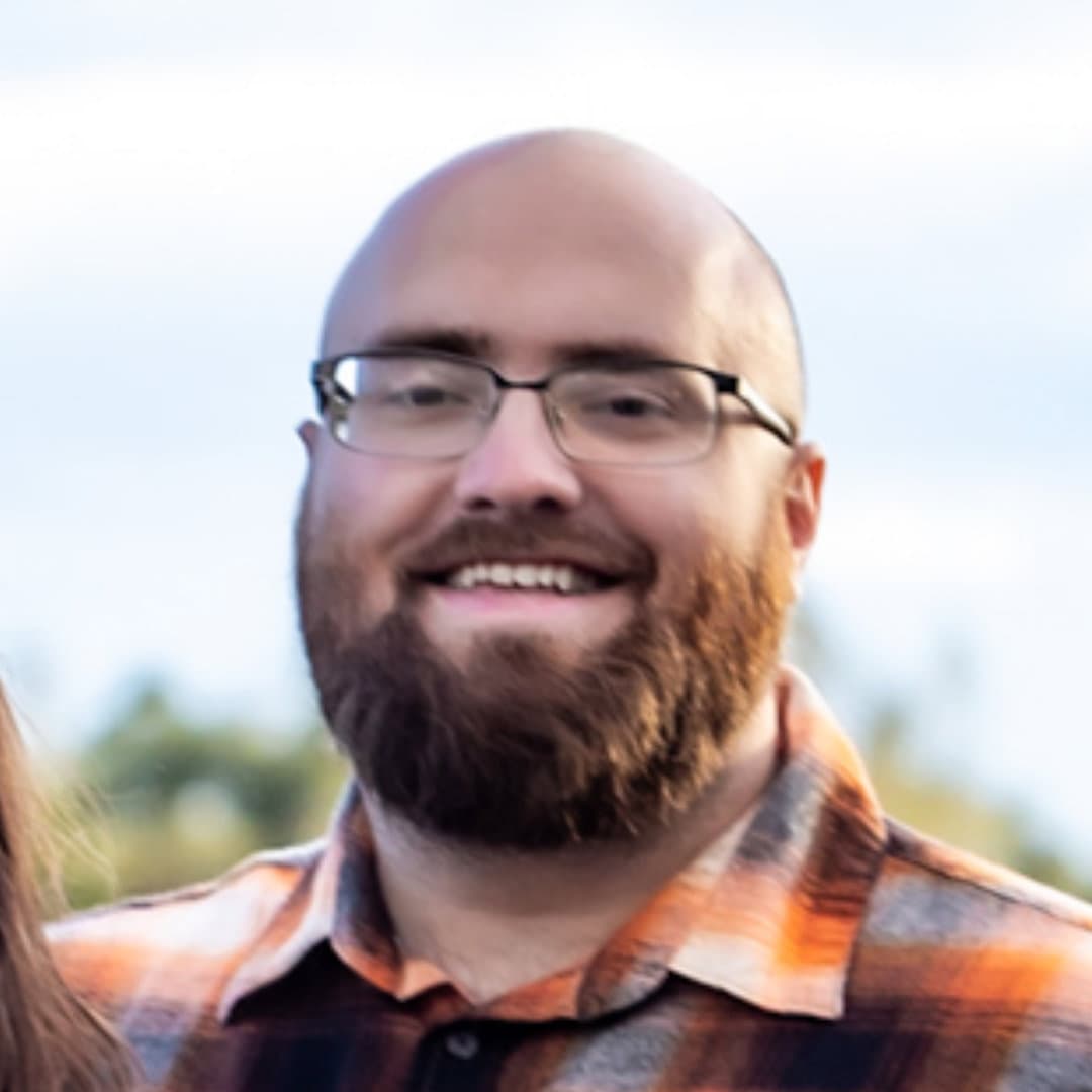 Profile picture of Christopher M Boyer's head in an orange flannel i guess